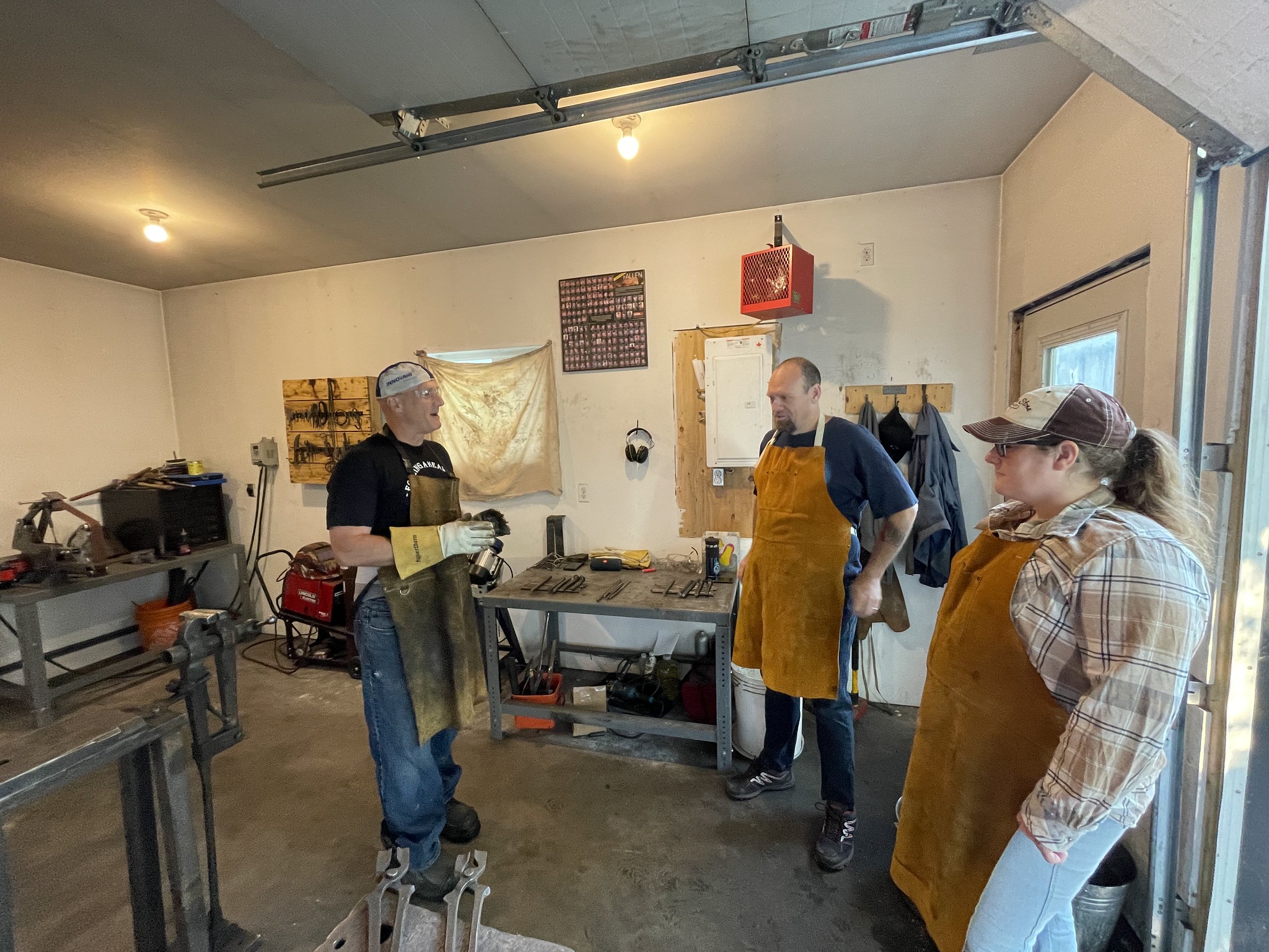 Three Soldier On members standing together during previous Blacksmithing event