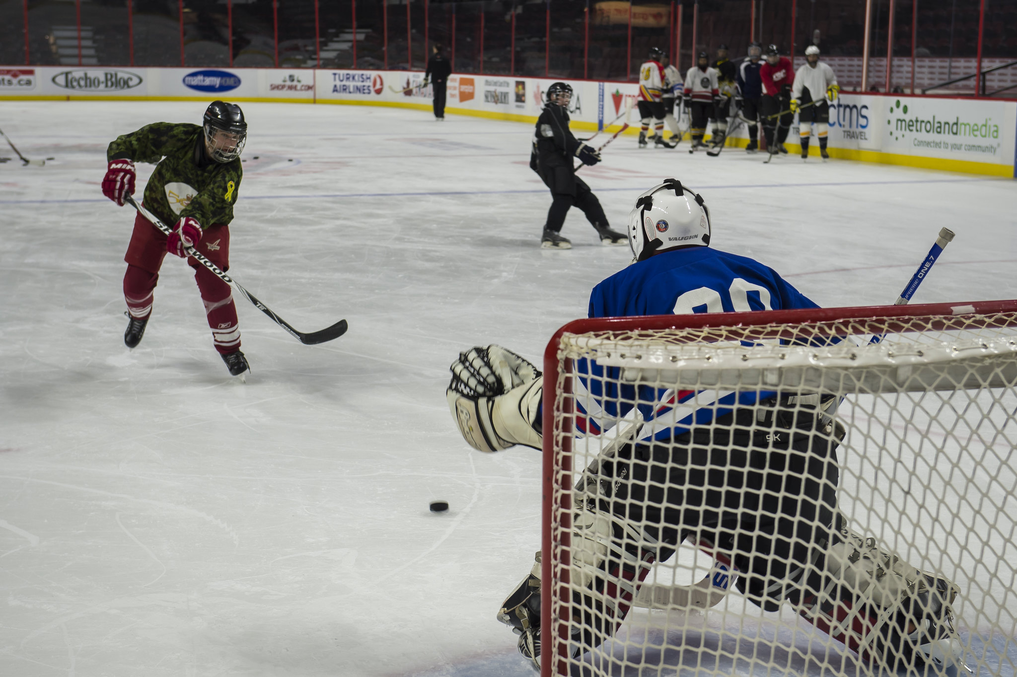 Soldier On members playing hockey on hockey rink